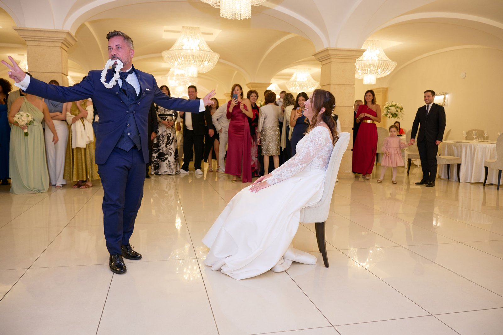 Alessandro dancing in front of Mariangela as their guests watch at Villa Vittoria in Boscotrecase.