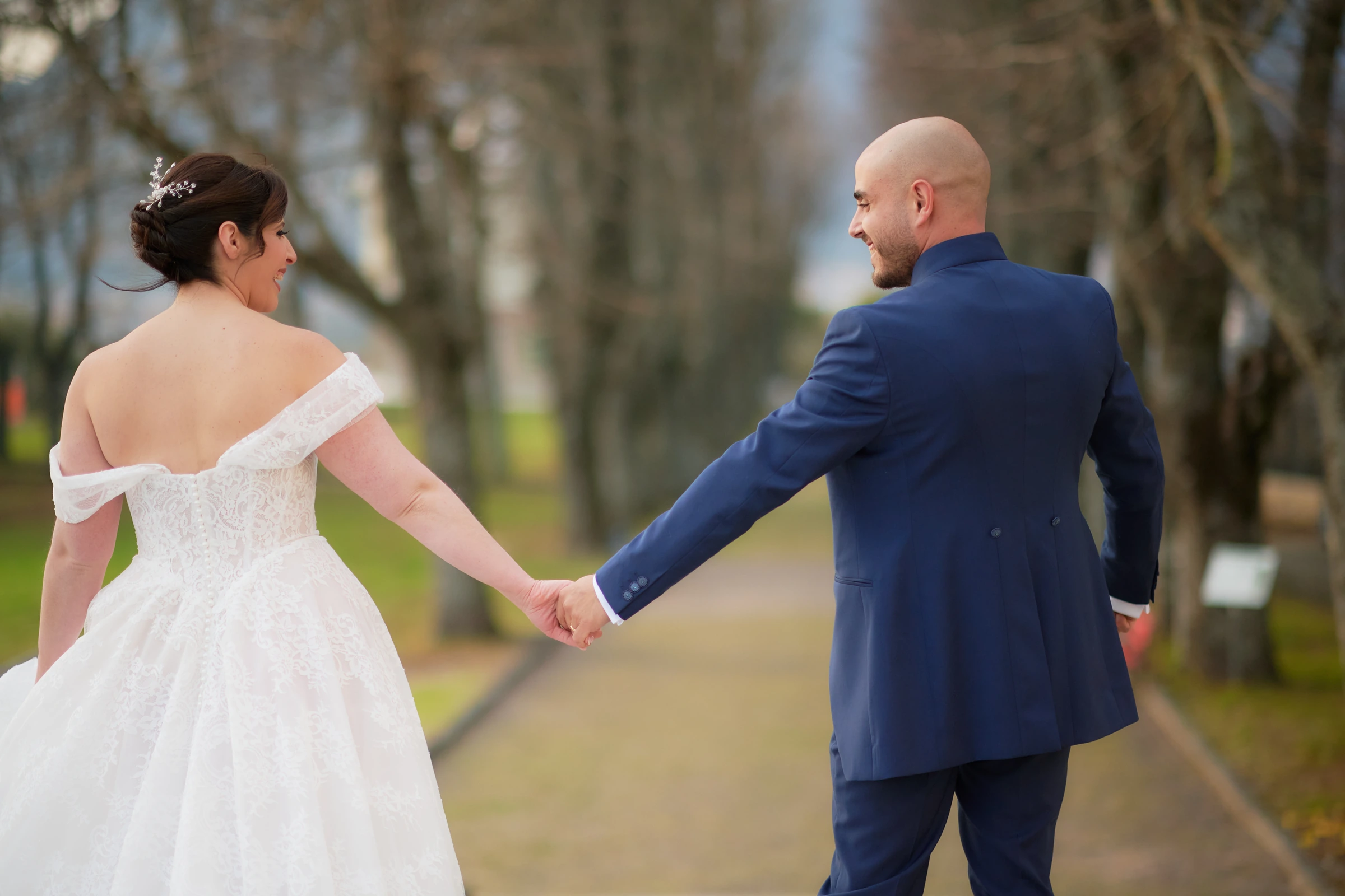 Ciro and Rosa holding hands and looking towards each other during their wedding portraits in Agerola.