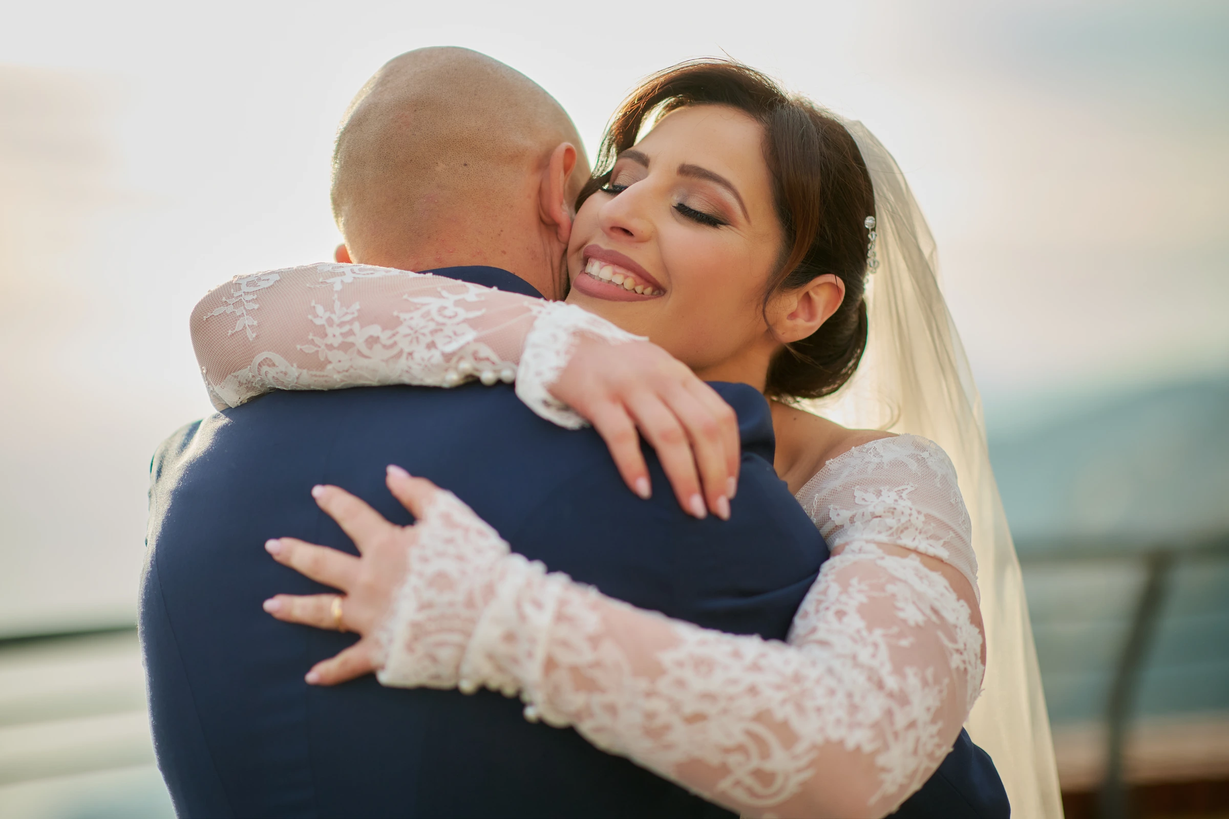 Rosa smiling as she embraces Ciro during their wedding portraits at the Belvedere in Agerola.