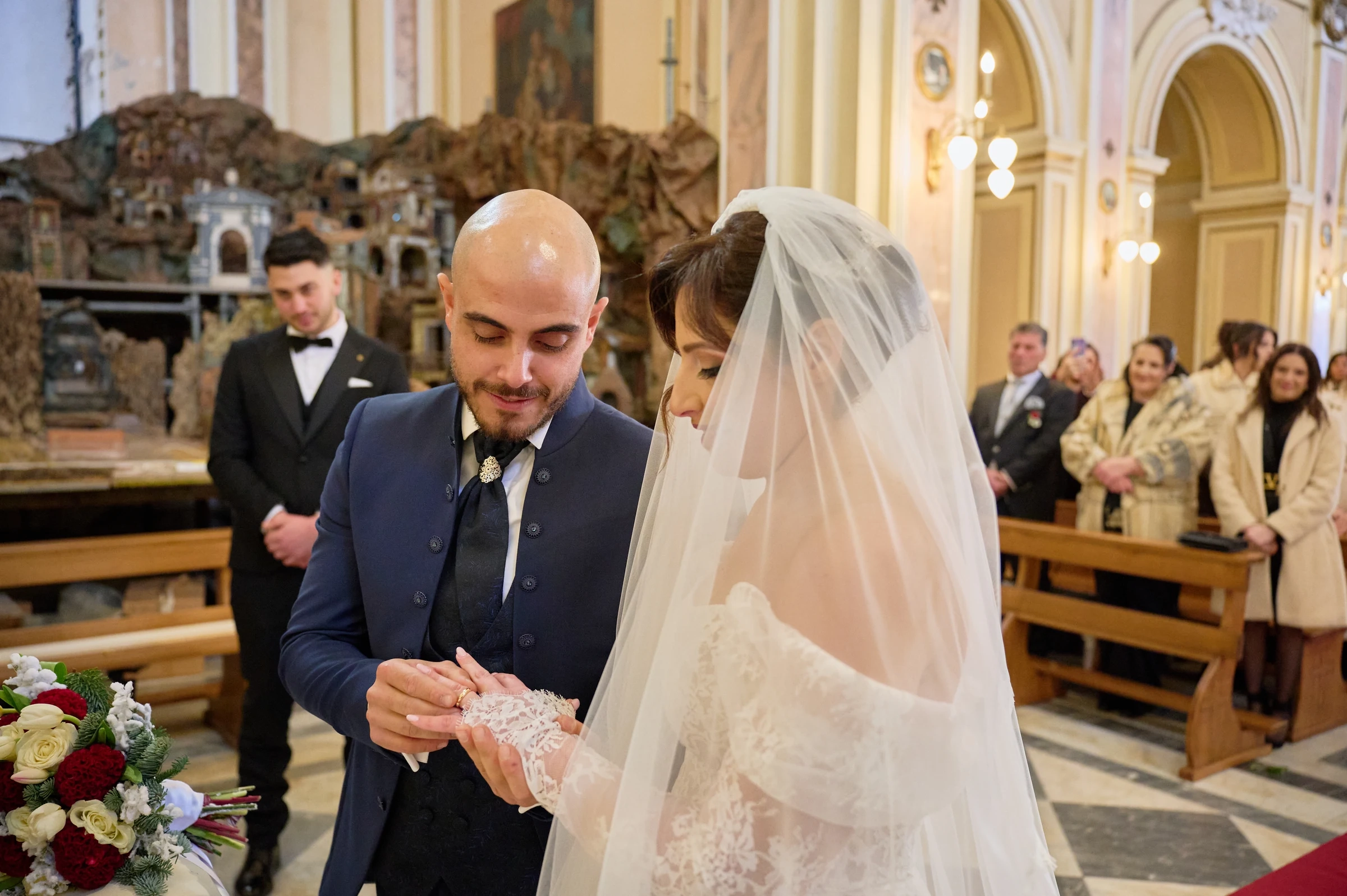 Ciro placing a wedding ring on Rosa’s finger during their ceremony at the sanctuary in Gragnano.