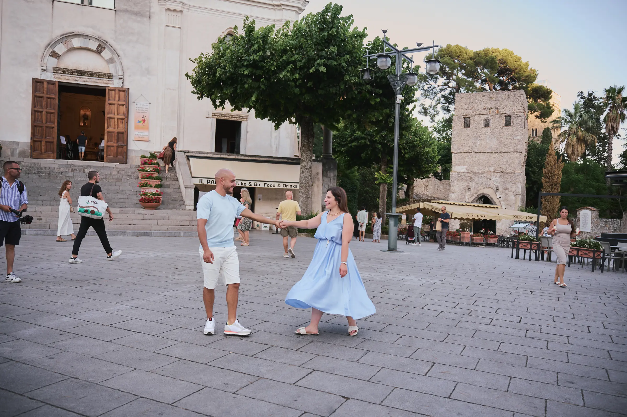Ciro and Rosa dancing together in a square in Ravello during their engagement photoshoot.