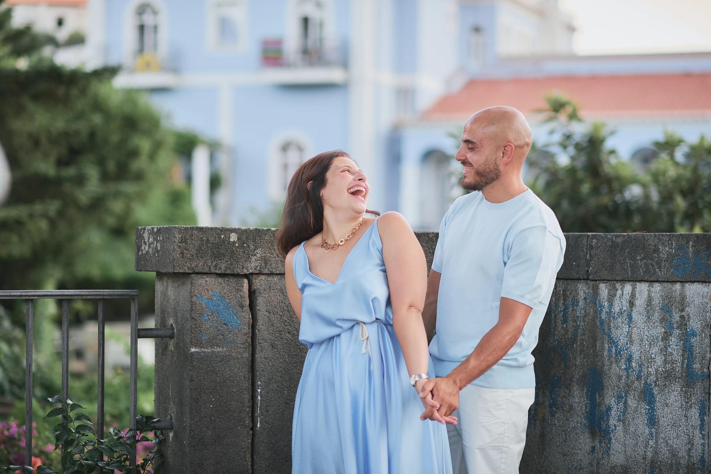 Rosa laughing beside Ciro as they hold hands during their engagement session in Ravello.