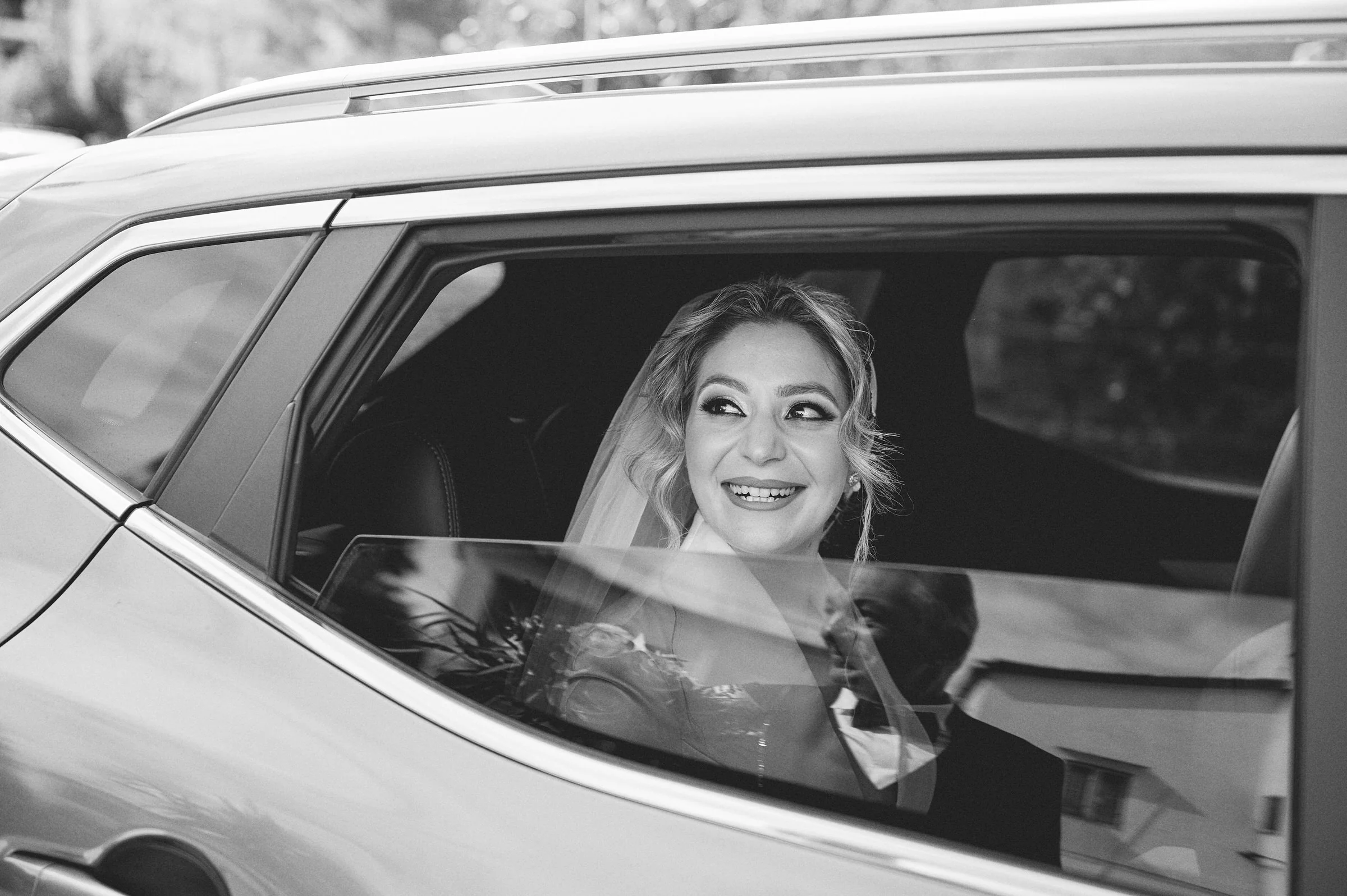 Black and white photograph of Clementina smiling through a car window on her wedding day in Gragnano.