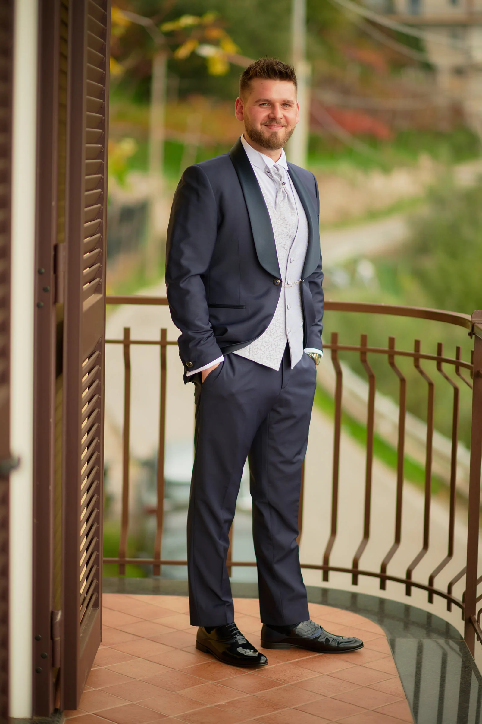 Matteo in his wedding suit on a balcony during preparations in Gragnano.