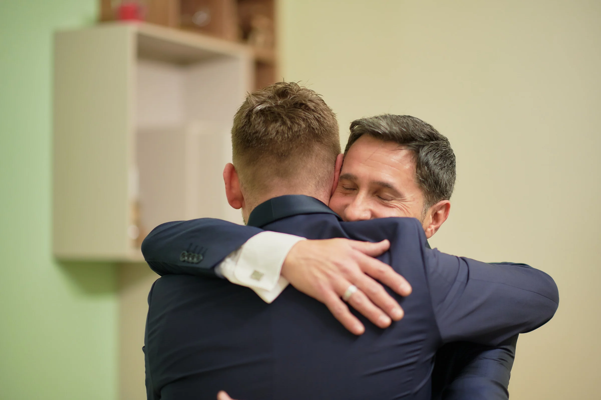 Matteo embracing his father during his wedding preparations in Gragnano.